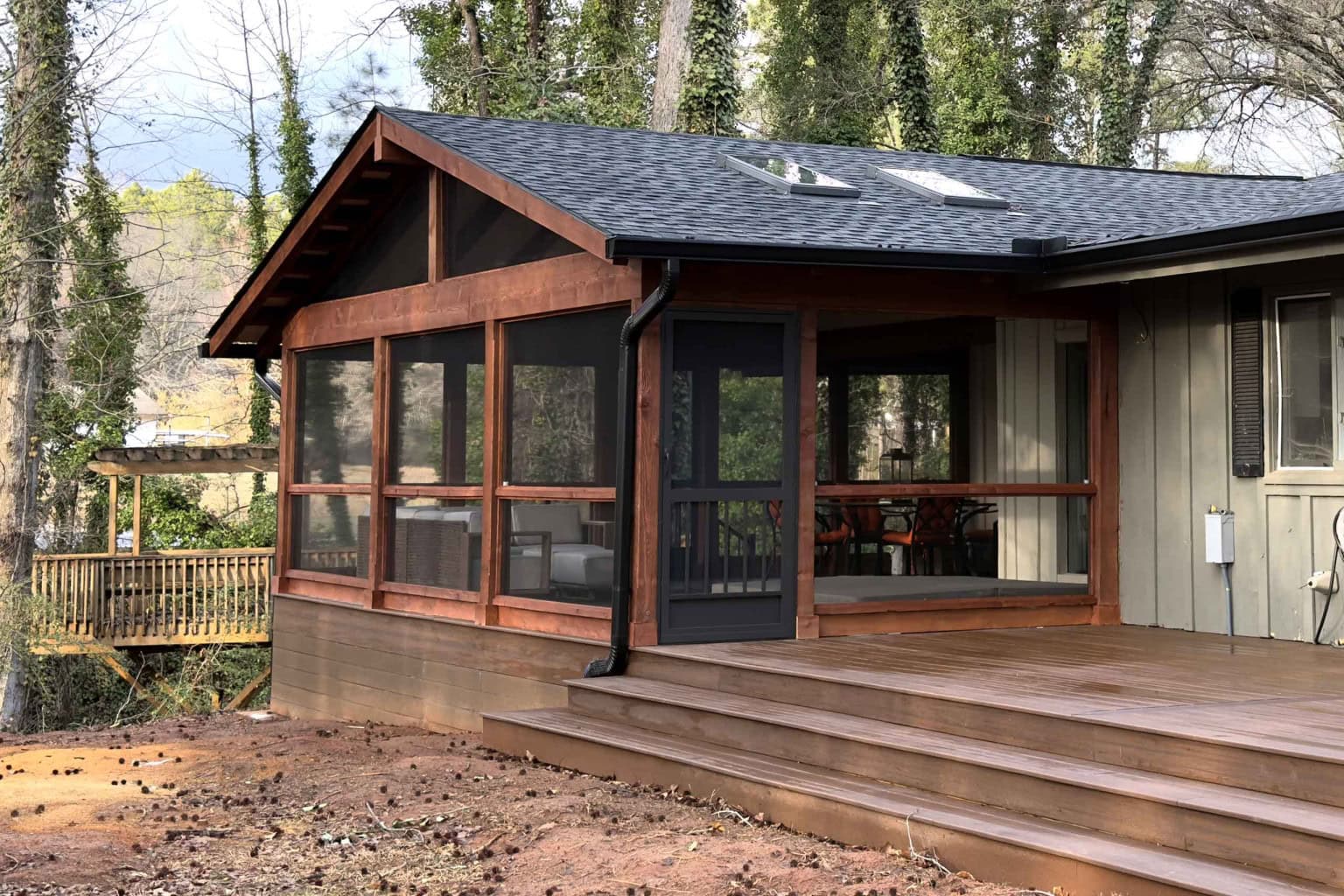 Connected Deck and Screened Porch — Greer SC Outdoor Living Screened door connecting open composite deck to screened porch on a custom outdoor living build in Greer, SC