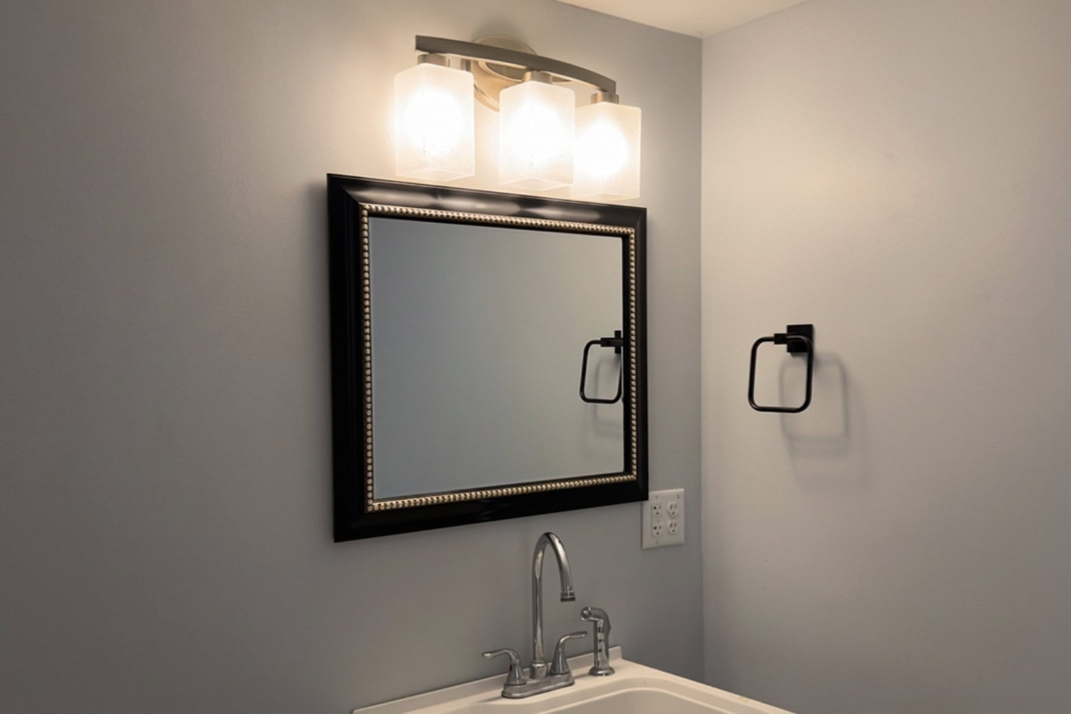 Bathroom vanity with mirror and lighting in finished garage remodel — Firefly Construction Greer Bathroom vanity with mirror and lighting in finished garage remodel Greer SC
