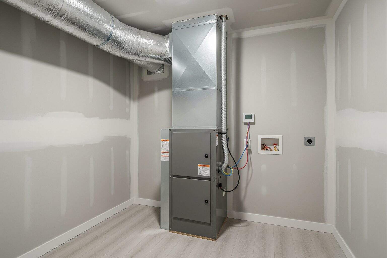 Indoor air handler installed in Upstate SC Indoor air handler installed in a clean Upstate SC utility room with visible ductwork overhead.